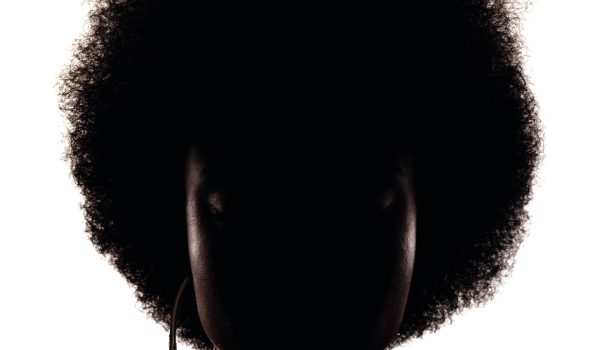 Silhouette portrait of african american girl with curly hair afro hairstyle isolated on white background.